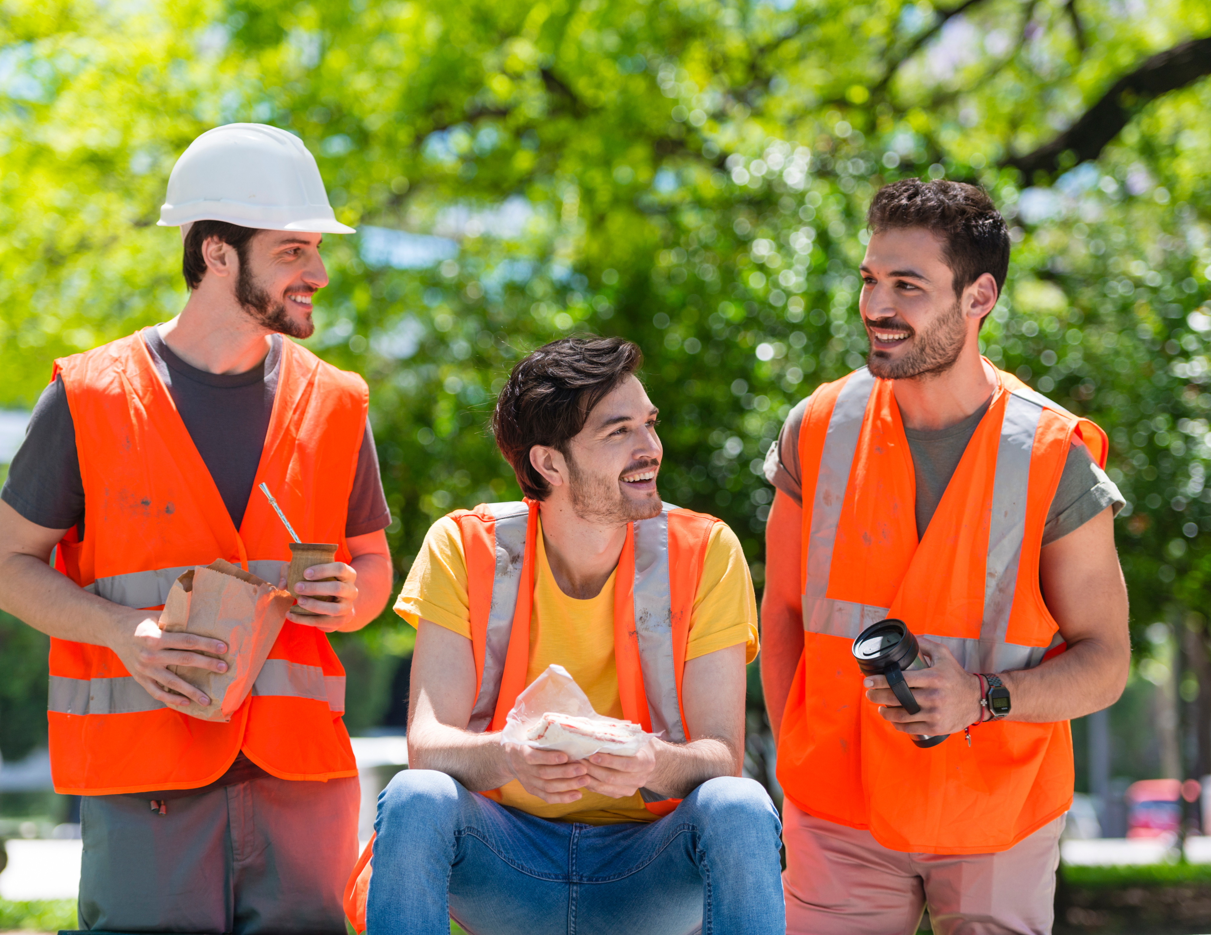 [Image from Canva - Men Sharing Lunch on Construction Site]